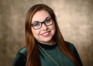 Porträt einer jungen Frau mit Brille, professionell und freundlich. - photoart hübner business Porträt einer jungen Frau mit Brille, lächelnd, in Business-Umgebung.
