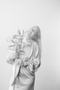 Frau mit Blumen, professionelles Personal Branding - photoart hübner business Frau hält Blumen und lächelt, ideal für Unternehmens- und Karrierefotos im Businessbereich.