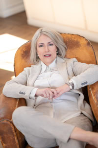 Erfolg im Business: Selbstbewusste Frau in Businesskleidung - photoart hübner business Selbstbewusste Businessfrau in eleganter Kleidung sitzt entspannt in einem Ledersessel.