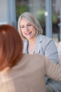 Fachgespräch zwischen zwei Frauen in einem modernen Büro - photoart hübner business Zwei Frauen im Gespräch in einem modernen Büro, professionelle Atmosphäre.